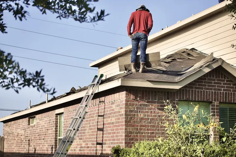 Professional roofer working on a residential roof in Downtown Camden